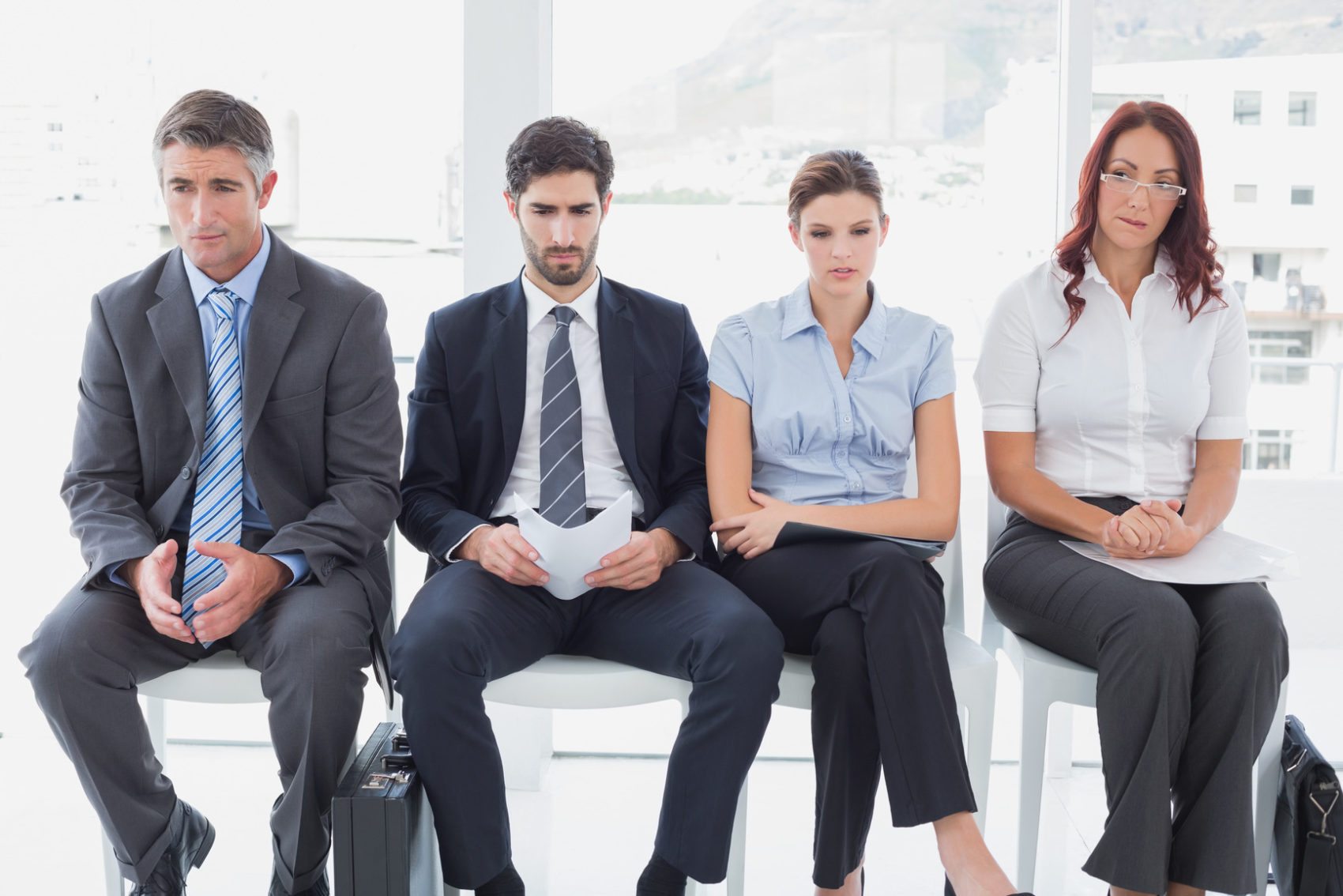 Business people sitting in a row in an office